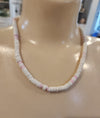 Vintage Puka shell necklace brings the island vibes! Features white and pink shells on a 17" strand