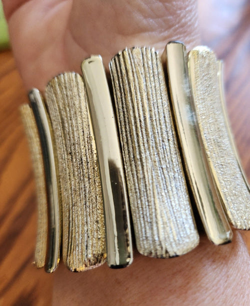 This vintage gold-tone bracelet boasts a striking design with textured panels