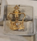 Gold tone Minature Royalty Crown lapel pin with sparking gems.