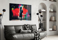 Hooded Kid Facing Red Paint Splash Glass Wall Art
